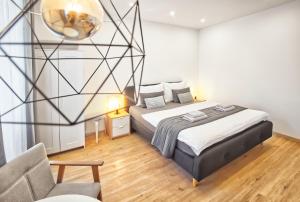 Posteľ alebo postele v izbe v ubytovaní Apartmány VIENNA