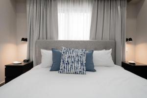 a bedroom with a large white bed with blue pillows at Breakfast included - 2 bedrooms - RL1 707 in La Julia