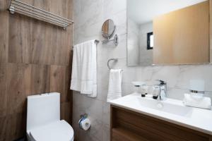 a bathroom with a sink and a toilet and a mirror at Breakfast included - 2 bedrooms - RL1 707 in La Julia +17 photos