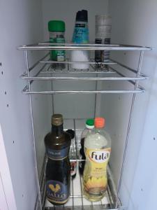 a refrigerator filled with lots of bottles of alcohol at Knowing Home 110sqm in Parede +16 photos
