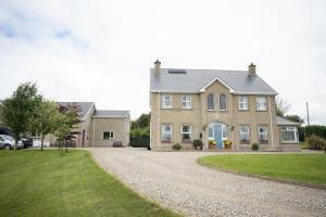 a large house with a gravel driveway in front of it at The Swilly Suite in Castlequarter