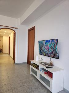 a living room with a flat screen tv on a wall at Beach view apartment in Cullera in Cullera
