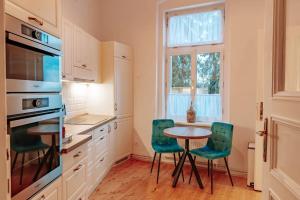 a kitchen with a table and chairs and a window at Aparmány Rozálie in Česká Lípa