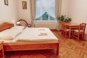 a bedroom with a bed and a table and a window at Aparmány Rozálie in Česká Lípa