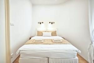 Posteľ alebo postele v izbe v ubytovaní Apartmány VIENNA