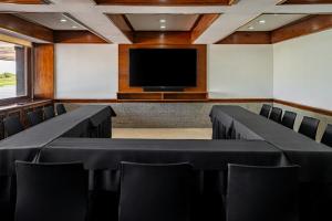 a conference room with chairs and a flat screen tv at Yacht & Golf Club Paraguayo, a Tribute Portfolio Resort in Asuncion +31 photos