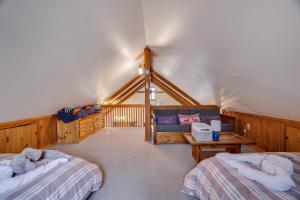 a bedroom with two beds and a couch at Moose Tracks Cabin Hot Tub 1 Mile To Lake in Lake Harmony