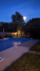a swimming pool at night with the moon in the sky at Private SweetSuite 1 Bdrm Bathroom mini-kitchen in Kamloops