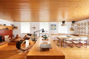 a living room with a couch and a table at VILLA MARGHERITA - 5 minutes from Dolomiti Super Ski in Ziano di Fiemme