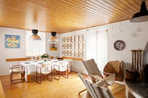 a dining room with a white table and chairs at VILLA MARGHERITA - 5 minutes from Dolomiti Super Ski in Ziano di Fiemme +36 photos
