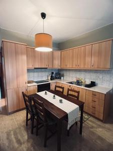 a kitchen with a table and chairs in it at Seaesta House in Keramotí
