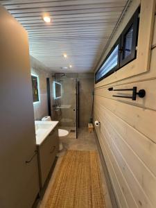 a bathroom with a sink and a toilet and a shower at Villa Terwaluoto in Oulu