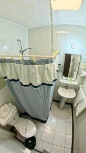 a bathroom with a tub and a toilet and a sink at Hotel Concorde in Arica +22 photos