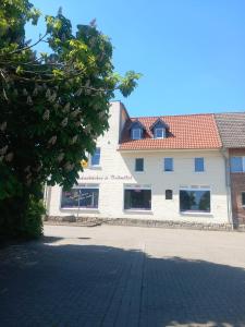 a large white building with a red roof at Thonic 1 in Quedlinburg
