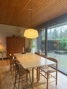a dining room with a wooden table and chairs at Enjoy Nature And Water In Rågeleje Near Vejby in Vejby