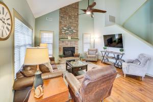 a living room with leather furniture and a fireplace at Pool and Lake Access Cozy Nest in Branson West in Branson West