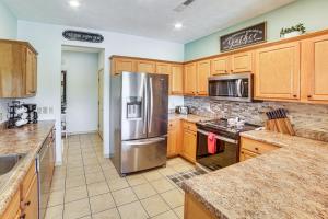 a kitchen with wooden cabinets and a stainless steel refrigerator at Pool and Lake Access Cozy Nest in Branson West in Branson West