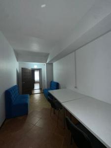 a room with two blue chairs and a table at Room Hostel Tolebi in Almaty