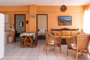 a living room with a couch and a table and chairs at Eutopia stay in Flogita