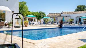 圣马迪拉莫Hotel La Tramontane的一名女子站在游泳池旁边