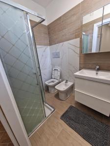 a bathroom with a toilet and a sink and a shower at Domus Conza in Nocera Inferiore +11 photos
