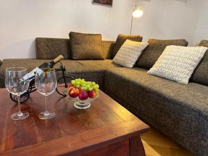 a living room with a couch and a table with wine glasses at Apartment Hviezdko - Heart of Old Town in Bratislava