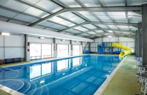 a large swimming pool with a slide in it at Dancing Seagulls Caravan in Clacton-on-Sea