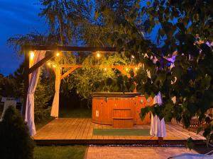 a gazebo with an outdoor kitchen at night at Magiczny Zakątek Bałtów in Bałtów +21 photos