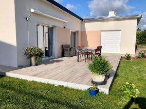 Lampaul-PlouarzelChez Yolande的庭院内带桌椅的甲板