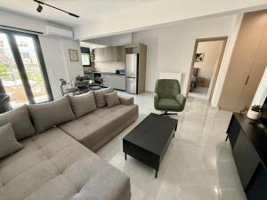 a large living room with a couch and a chair at Comfort SpataAir Stay in Spata