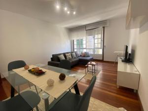 a living room with a table and a couch at A dos Pasos in Caldas de Reis