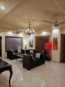 a living room with couches and a projection screen at Serenity Suite 2 BHK LHR in Lahore