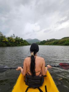 a woman in a kayak on a river at Playas De Casa Grande in Santa Marta
