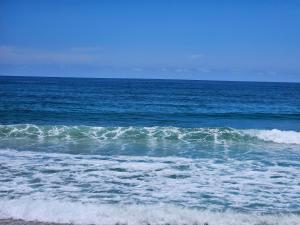 a large body of water with waves on the beach at Playas De Casa Grande in Santa Marta +1 photo