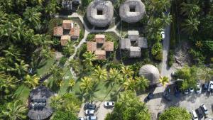 an aerial view of a resort with palm trees and cars at Playas De Casa Grande in Santa Marta