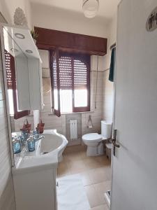 a bathroom with a sink and a toilet at Loft Giudina in Taormina +24 photos