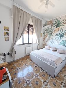 a bedroom with a bed and a large window at Loft Giudina in Taormina