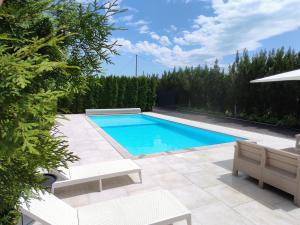 a swimming pool in the backyard of a house at Natural Cottage Una in Bihać