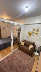 a living room with a couch and a bed at Condominium Luxury 1 bedroom, impressive amenities in Davao City