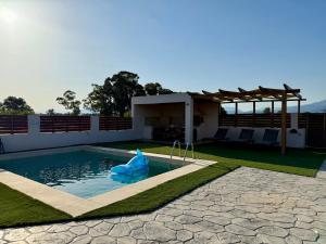 a swimming pool with a blue inflatableigator in the water at Aristea Seaside Retreat with Private Pool in Kalamaki Heraklion