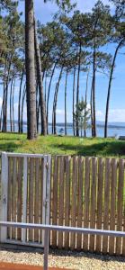 a bench sitting in front of a wooden fence at Apartamento Cabodeiro Paradise in Isla de Arosa +1 photo