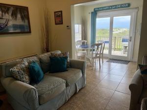 a living room with a couch and a table at Beachgate Condo Suites and Hotel 121 condo in Port Aransas