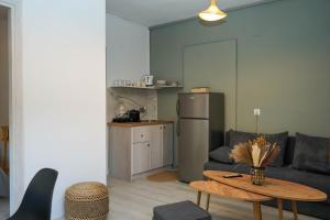 a living room with a couch and a table at Bougainvillea Loft in Parga