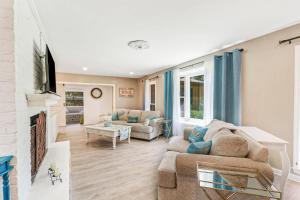 a living room with a couch and a fireplace at 1 Block to Ocean Fun in Hilton Head Island