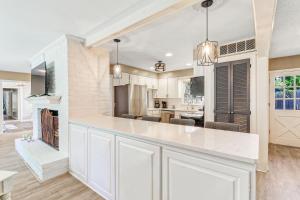 a kitchen with white cabinets and a white counter top at 1 Block to Ocean Fun in Hilton Head Island