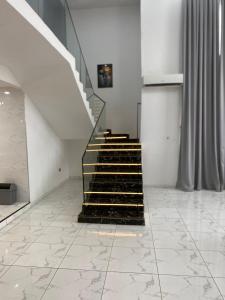 a staircase in a room with a tile floor at The Residence in Kwabenya +2 photos