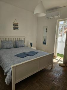 a bedroom with a bed with blue towels on it at Lagos Haven Guesthouse in Lagos