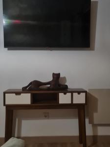 a wooden table with a television on a wall at Zen Casa House in Gijón