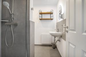 a bathroom with a shower and a sink at Ferienwohnung Nordseeheimat Pellworm in Pellworm +13 photos