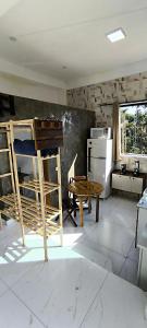 a kitchen with a stove and a table in a room at Chalé Completo Com Linda Vista para o Mar de Ilhabela 2 in Ilhabela